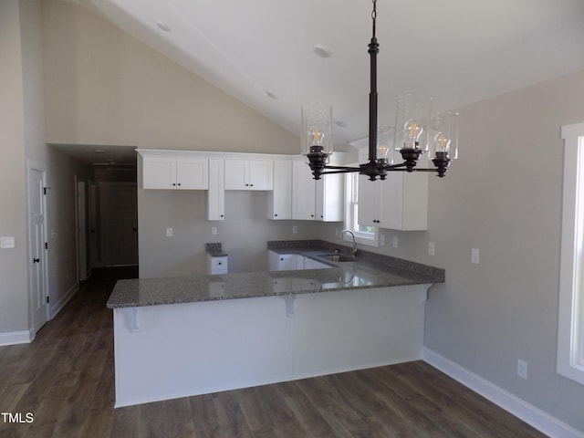 104 Halifax Rd, Louisburg, NC 27549 - kitchen with stone counters, a sink, an inviting chandelier, baseboards, and a peninsula