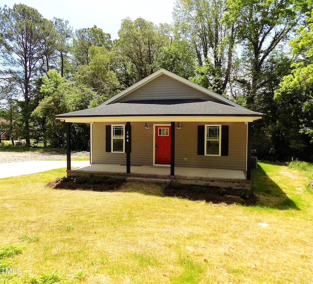 104 Halifax Rd, Louisburg, NC 27549 - view of front of home with a shingled roof, covered porch, and a front yard