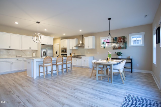 dining room with light hardwood / wood-style floors and sink