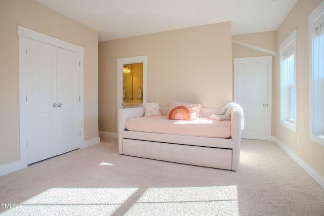 carpeted bedroom with a closet