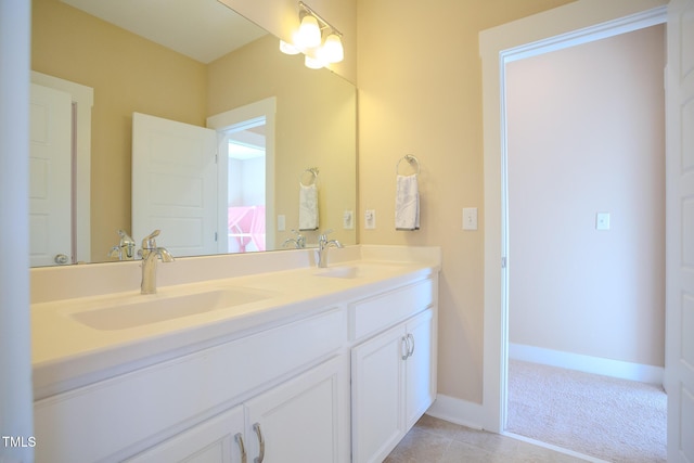 bathroom with tile patterned floors, vanity, and an inviting chandelier