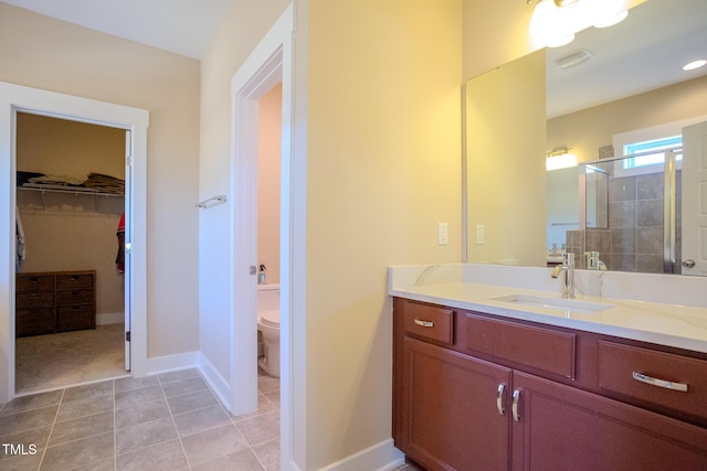 bathroom featuring toilet, vanity, and walk in shower