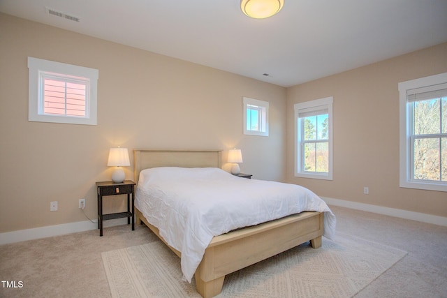 bedroom featuring light carpet