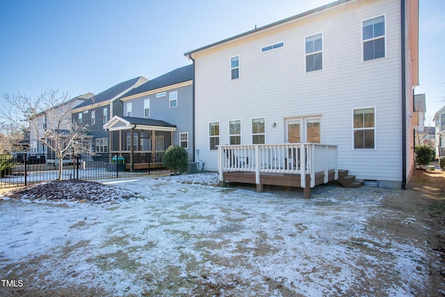 snow covered property featuring a wooden deck