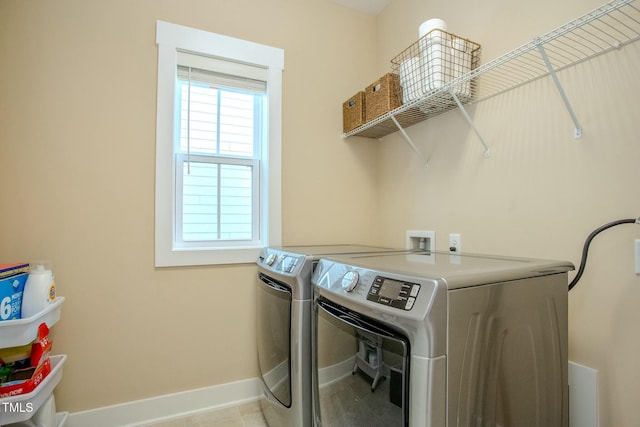 washroom with washing machine and dryer and light tile patterned flooring