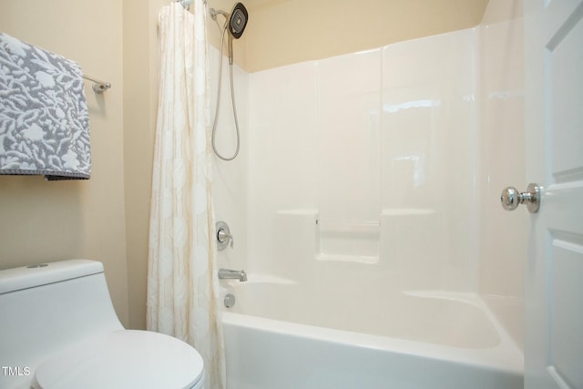 bathroom featuring shower / bath combo with shower curtain and toilet