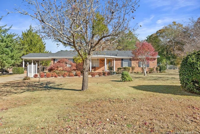 ranch-style house with a front yard and a carport