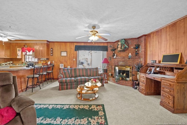 living room featuring a brick fireplace, wood walls, and ornamental molding