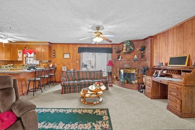 living room with a textured ceiling, wood walls, crown molding, and light carpet