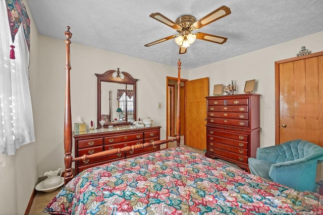 bedroom with a textured ceiling, ceiling fan, and carpet flooring