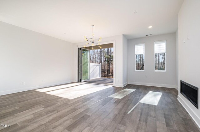 interior space featuring dark hardwood / wood-style flooring and an inviting chandelier