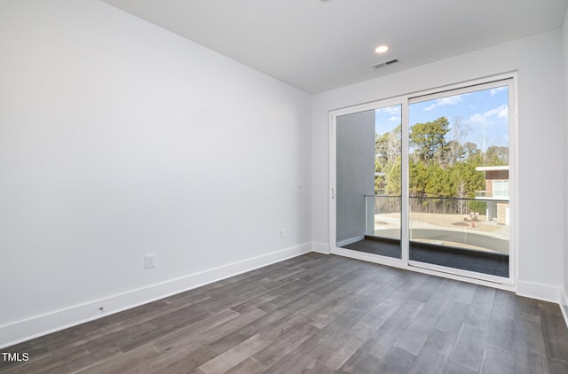 unfurnished room with dark hardwood / wood-style floors