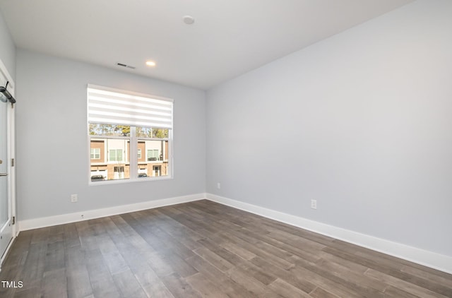 spare room with dark hardwood / wood-style flooring