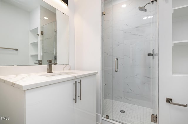 bathroom featuring an enclosed shower and vanity