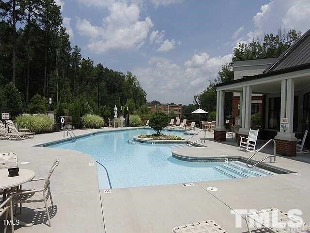 view of pool with a patio area and a hot tub