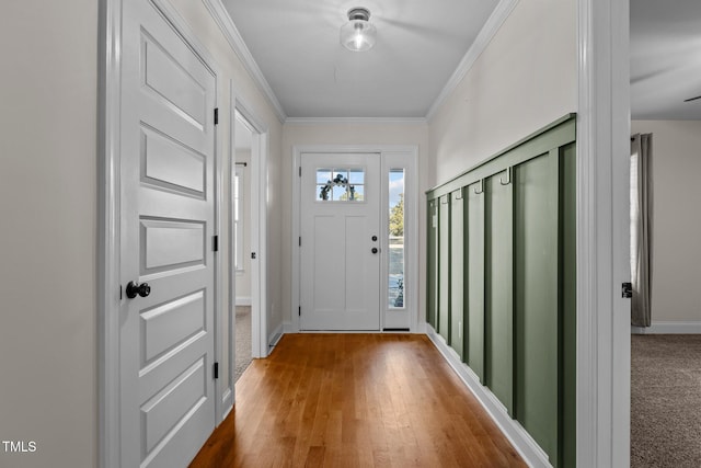 doorway to outside featuring ornamental molding and wood-type flooring