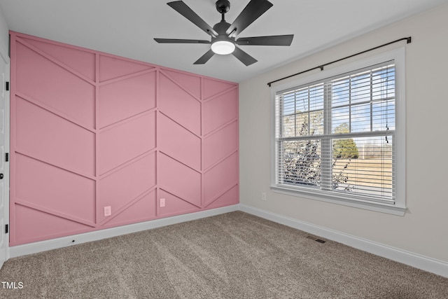 carpeted empty room featuring ceiling fan