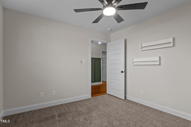 spare room with ceiling fan and carpet flooring