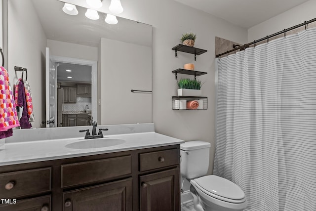 bathroom with toilet, vanity, backsplash, and walk in shower