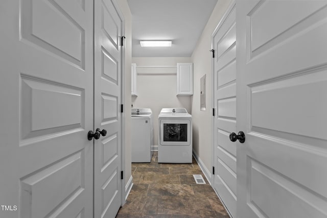 laundry room featuring cabinets and separate washer and dryer