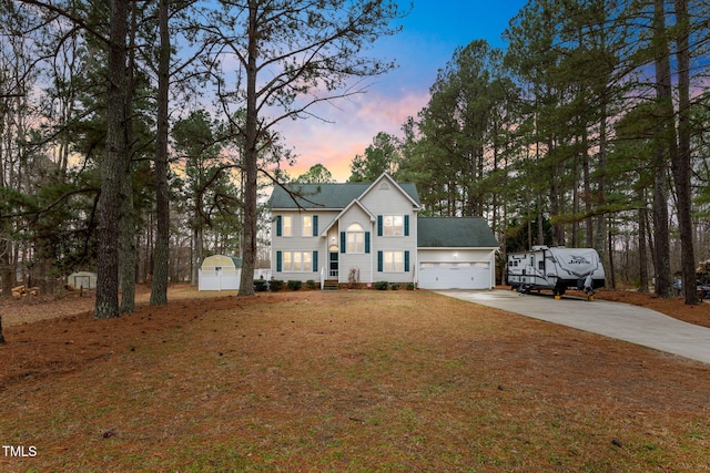 view of front of home featuring a yard and a garage