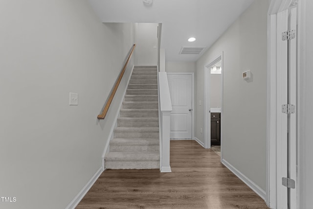 stairway featuring hardwood / wood-style floors