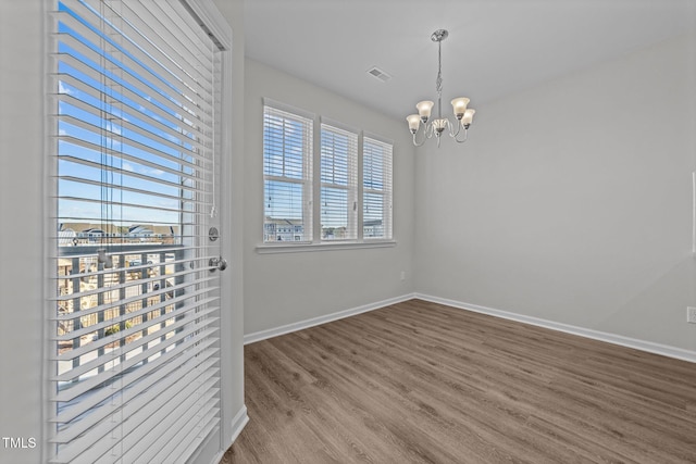 interior space with hardwood / wood-style floors and a notable chandelier