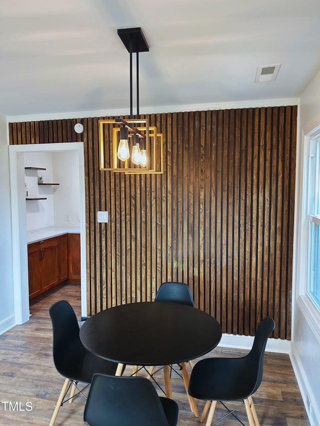 dining space with an inviting chandelier and hardwood / wood-style flooring