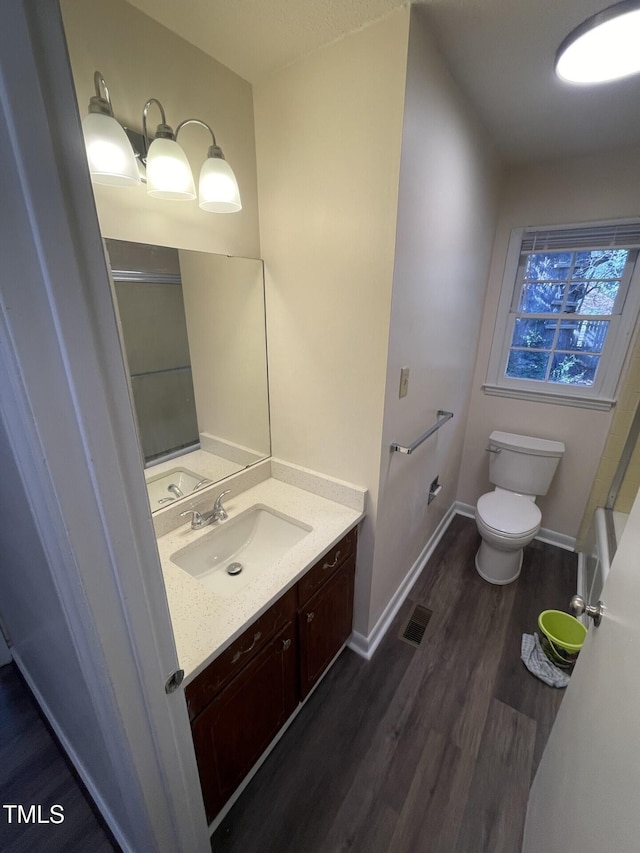 bathroom featuring hardwood / wood-style flooring, vanity, and toilet