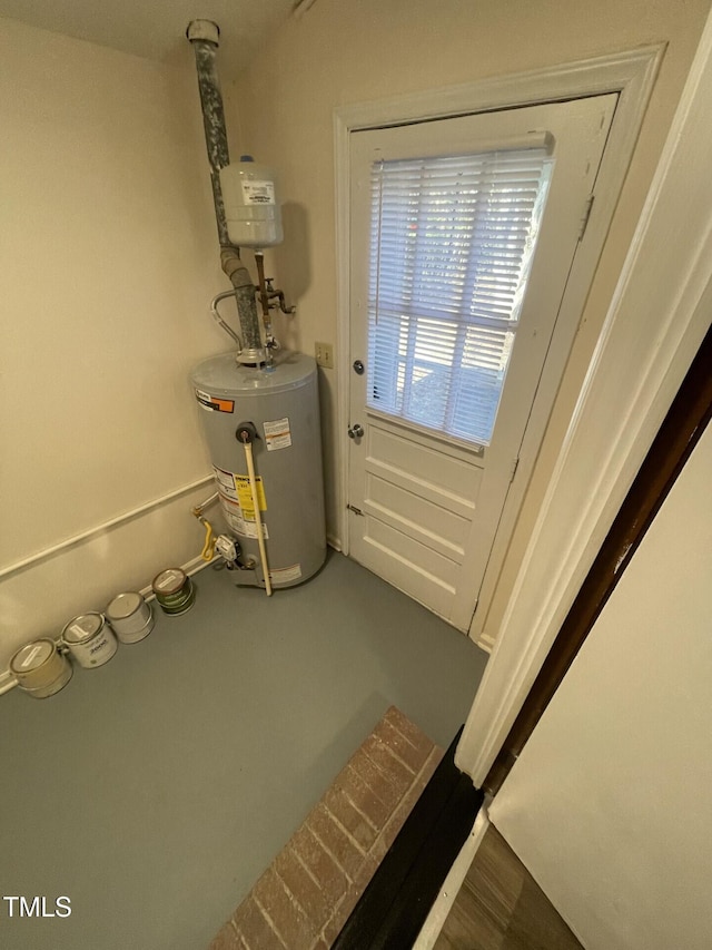 utility room featuring water heater