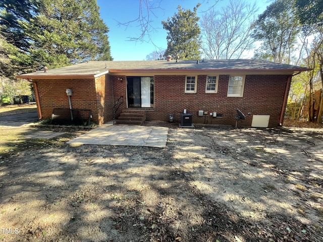 rear view of house with central AC and a patio area