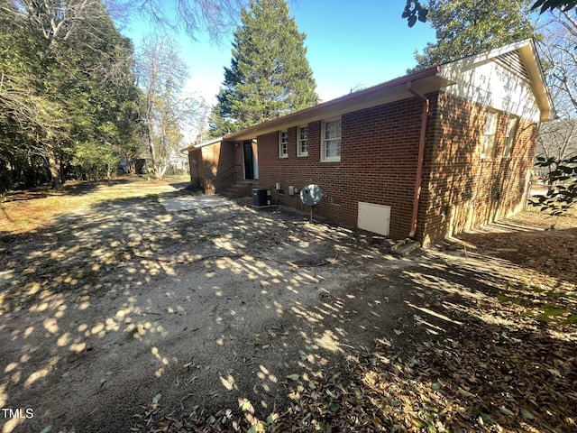 view of side of property with central AC