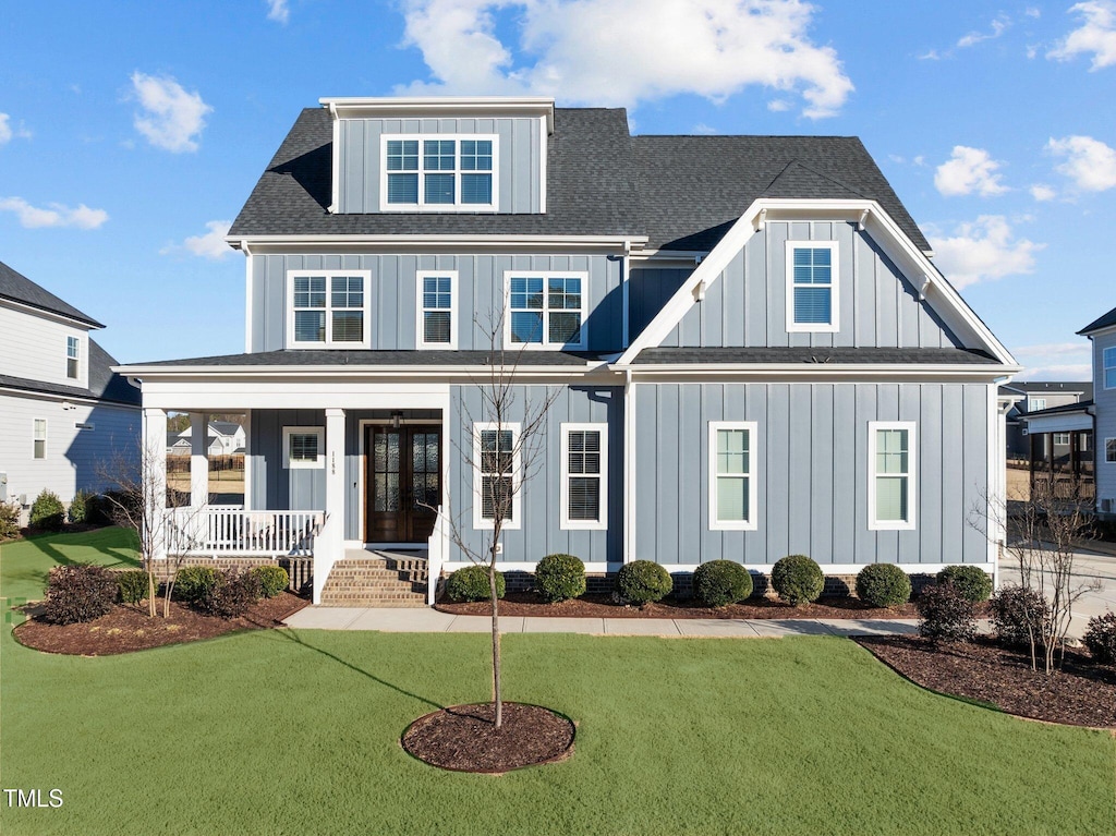 view of front of house with a front yard and covered porch