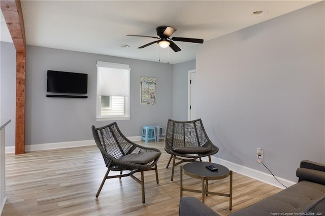 living area with ceiling fan and light wood-type flooring