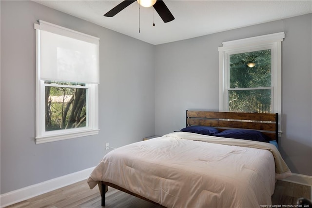 bedroom with ceiling fan and light hardwood / wood-style floors