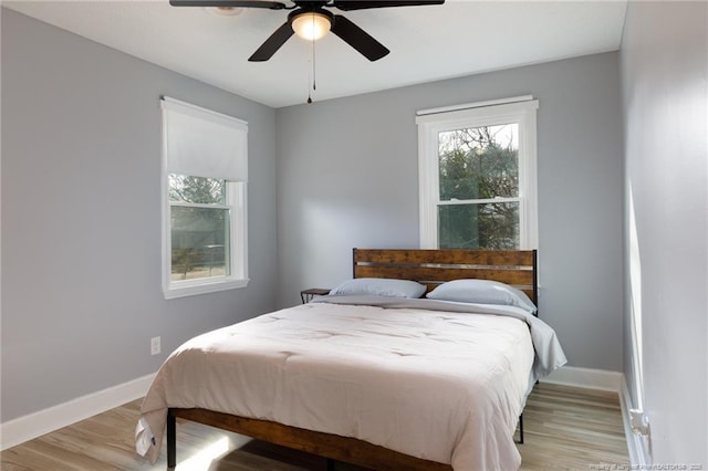 bedroom with ceiling fan and light hardwood / wood-style flooring