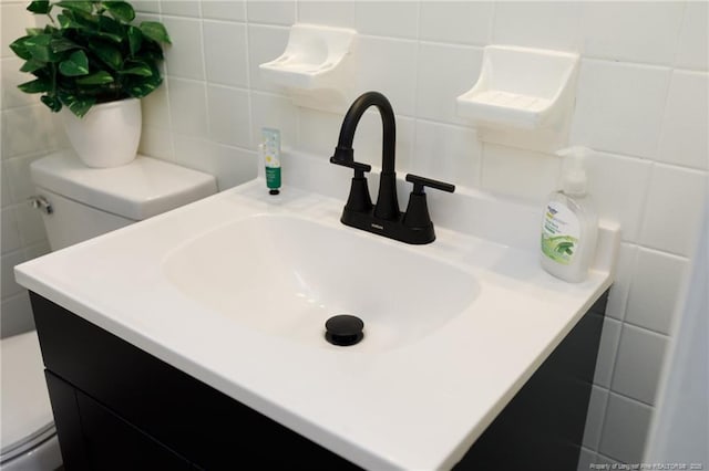 bathroom featuring tile walls, vanity, tasteful backsplash, and toilet