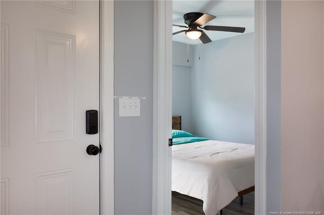 bedroom with ceiling fan and hardwood / wood-style flooring