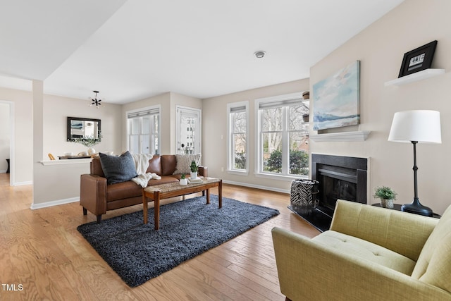 living room featuring light hardwood / wood-style flooring and an inviting chandelier