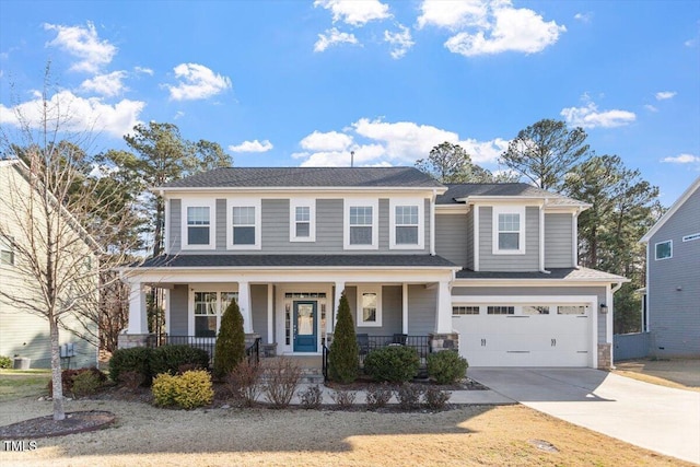 view of front facade with a porch, an attached garage, and driveway