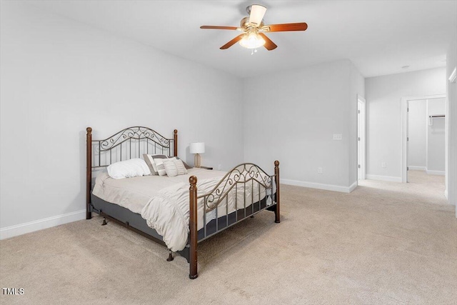 bedroom featuring ceiling fan, baseboards, and light carpet