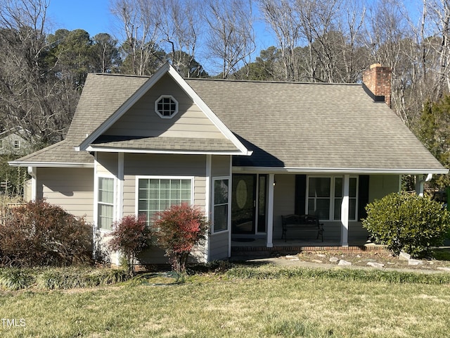 view of front of property with a porch and a front lawn