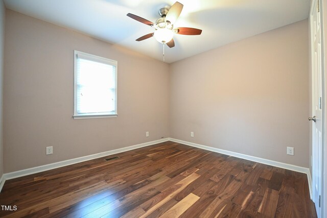 spare room featuring ceiling fan and dark hardwood / wood-style floors