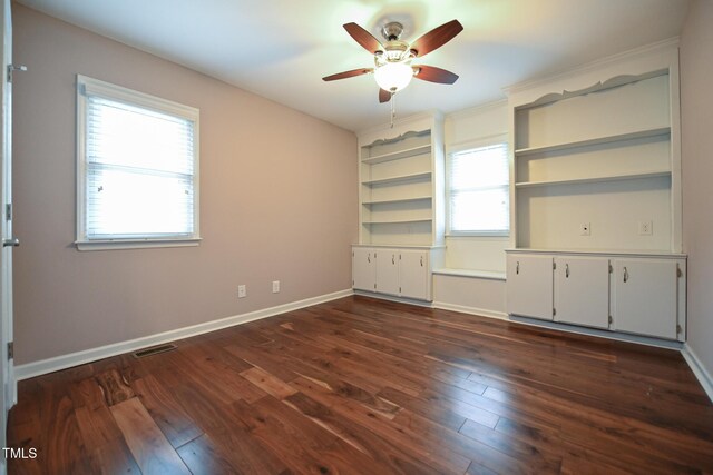 unfurnished bedroom featuring dark wood-type flooring and ceiling fan