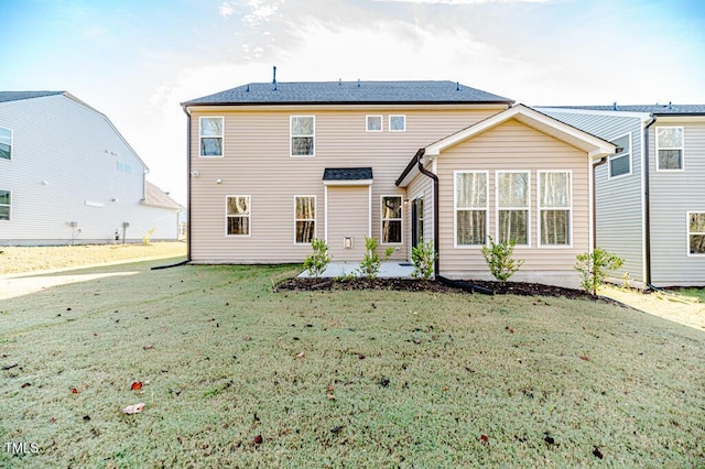 rear view of house with a patio area and a lawn