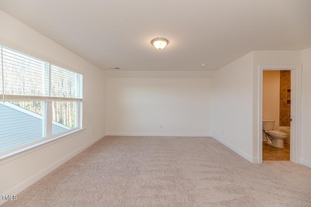 spare room featuring light colored carpet