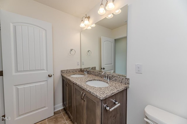 bathroom featuring toilet, tile patterned flooring, and vanity