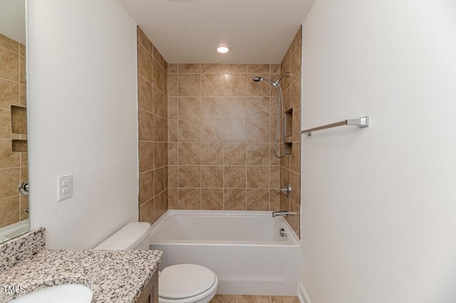 full bathroom featuring toilet, tiled shower / bath, and vanity