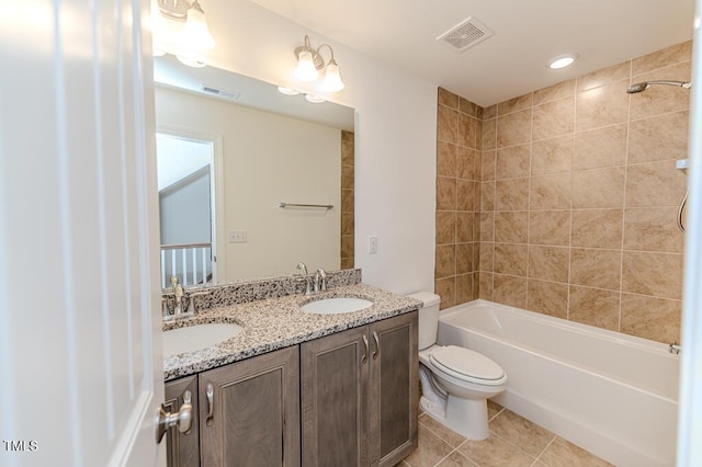 full bathroom with toilet, tile patterned flooring, vanity, and tiled shower / bath