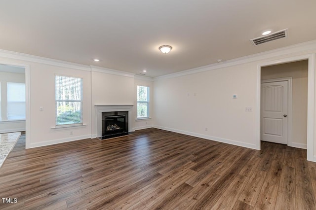 unfurnished living room featuring ornamental molding, dark hardwood / wood-style flooring, and plenty of natural light